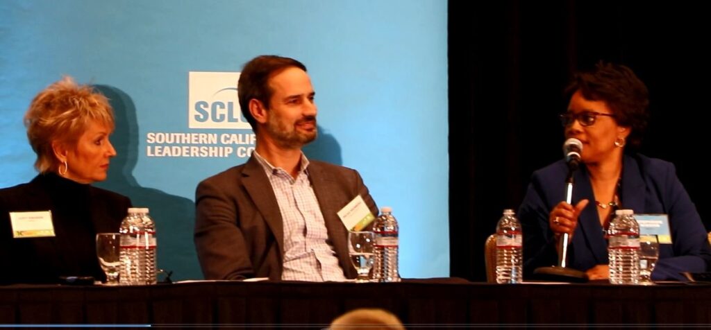 Stephanie Wiggins, CEO of Metrolink (R) speaks, as CalForward's Micah Weinberg and LAEDC's Judy Kruger look on.